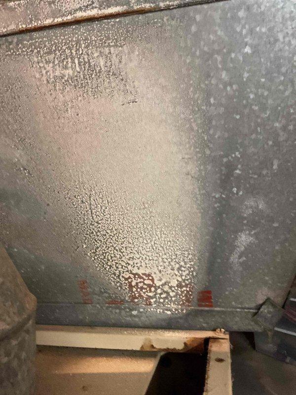 Diagnosed a 41-year-old furnace exhibiting a clunking noise and short-cycling shutdowns. Inspection of the supply plenum and ductwork revealed heavy frost and condensation buildup on the galvanized sheet metal, along with surface rust on the adjacent support framing, indicating age-related deterioration. Due to the unit's age and condition, replacement was recommended, and the customer has scheduled a follow-up in-home estimate for a new system.
