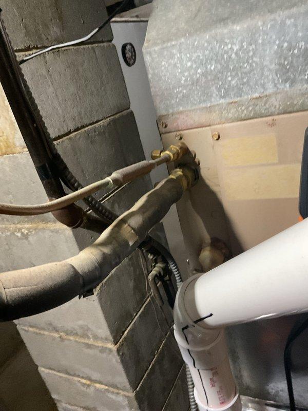Performed a furnace clean and tune-up on a gas furnace in a basement mechanical space, including inspection of the cabinet, PVC intake/exhaust venting, ductwork connections, and electrical conduit. Inspected the refrigerant line set, insulation, and connections at the air handler panel and confirmed no frost, ice, or active leaks. The system was checked and found in good condition, ready for the facility's state inspection requirements.