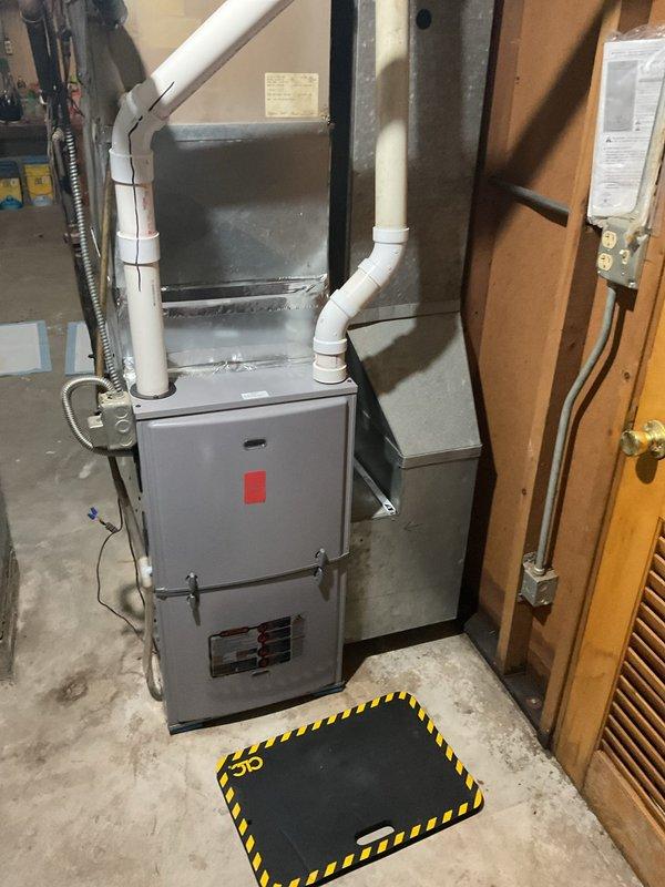 Performed a furnace clean and tune-up on a gas furnace in a basement mechanical space, including inspection of the cabinet, PVC intake/exhaust venting, ductwork connections, and electrical conduit. Inspected the refrigerant line set, insulation, and connections at the air handler panel and confirmed no frost, ice, or active leaks. The system was checked and found in good condition, ready for the facility's state inspection requirements.