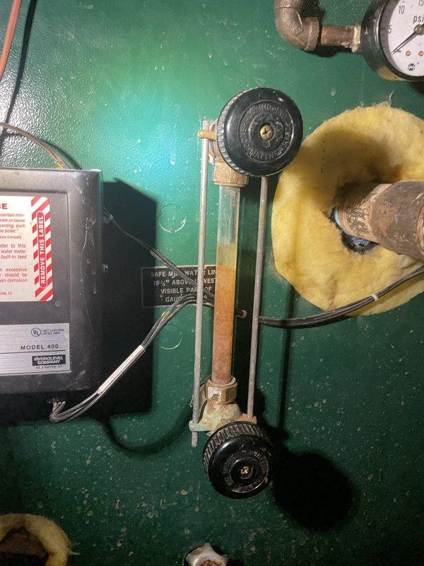 Performed a boiler tune-up and safety inspection, including a combustion analysis of the flue gases with a digital analyzer, and checked the gas train, controls, and pressure gauge for proper operation. Noted a heavily stained and sediment-filled water sight glass and corroded fittings, and recommend glass replacement and further evaluation of the system piping.