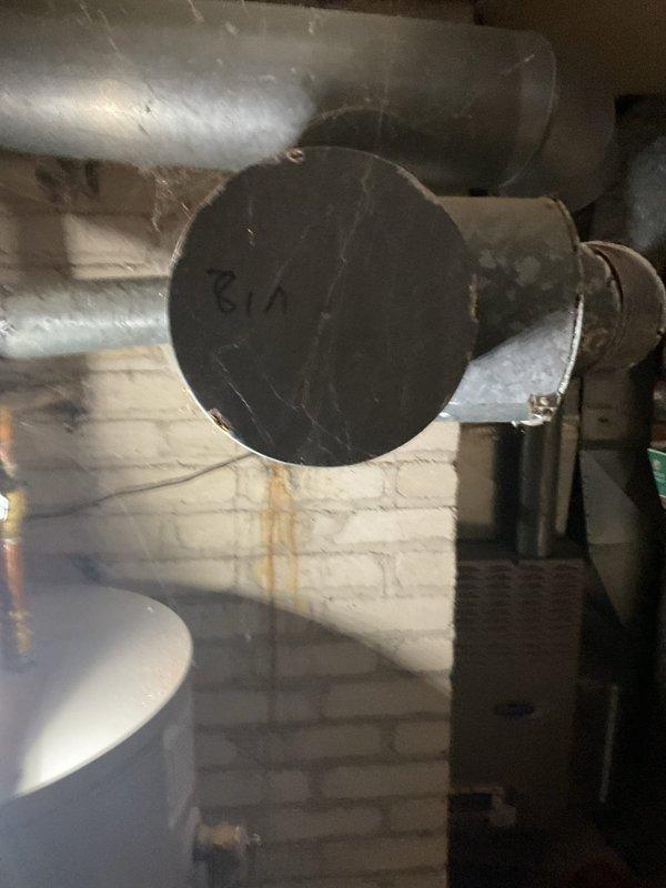 Diagnosed a no-heat condition on a 10-year-old furnace and found a large hole in the flue vent connector at the chimney, creating a combustion venting hazard. Installed a new chimney liner and re-vented the furnace and water heater into the new liner, then restored both appliances to operation and verified proper heat output.