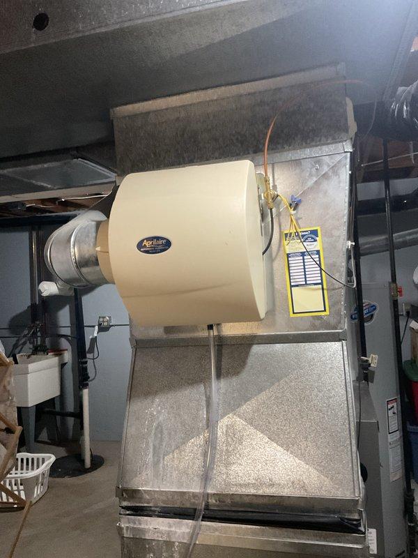 Performed a furnace tune-up on a 20+ year old gas unit, including cleaning and inspecting the burner assembly, wiring, and internal components, and evaluated blower operation per the customer's request for possible replacement. Inspected the attached Aprilaire humidifier, supply line, and drain tube, and verified overall system condition with no visible rust, frost, or breakage noted.