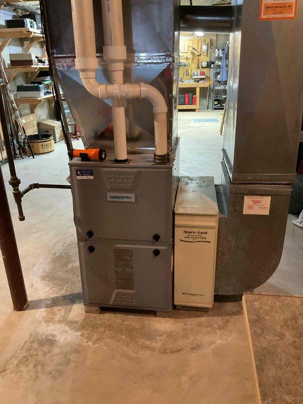 Performed a complete maintenance tune-up on an 11-year-old Comfortmaker gas furnace, including cleaning the unit and inspecting its components, with a carbon monoxide check completed. The furnace was found to be operating normally, with no deficiencies or repairs required.