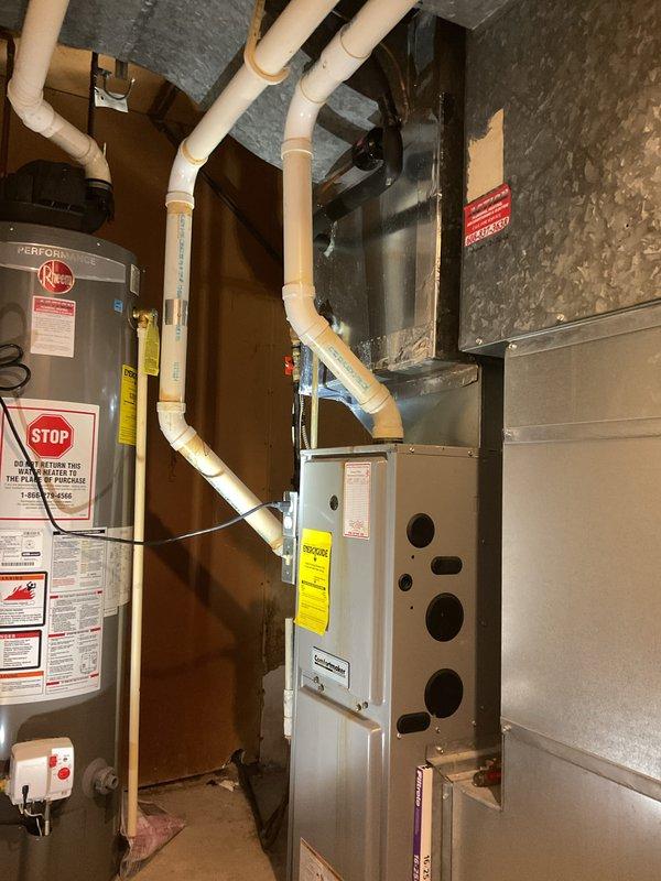 Performed a furnace cleaning and safety inspection on a gas furnace located in the basement mechanical area, and documented the furnace, venting, and ductwork with photos. Noted discoloration at several PVC vent/condensate joints for monitoring, and gathered equipment information for furnace and AC replacement budget estimates and a mini-split evaluation of the finished attic space.