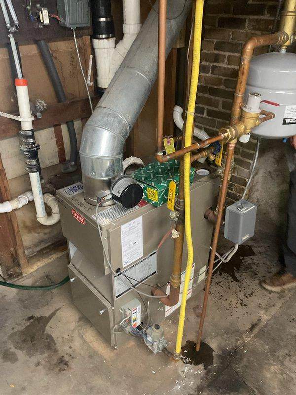 Removed the failed boiler pressure relief valve and installed a new relief valve, soldering it into the existing copper piping. Refilled the system with water and purged air to confirm proper operation, with the unit circulating normally and no leaks at the new connection.