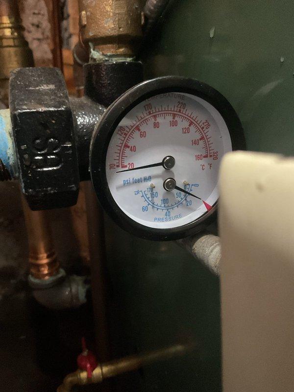 Performed a boiler cleaning and system inspection to address low system water pressure. Disassembled and cleaned the backflow preventer multiple times to restore water flow to the system. Isolated the expansion tank and recharged its air precharge to 18 psi, then adjusted the water feed valve to maintain 18 psi system fill pressure, which had dropped below the proper operating level.