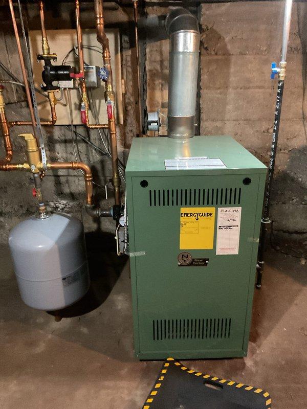 Performed a boiler cleaning and system inspection to address low system water pressure. Disassembled and cleaned the backflow preventer multiple times to restore water flow to the system. Isolated the expansion tank and recharged its air precharge to 18 psi, then adjusted the water feed valve to maintain 18 psi system fill pressure, which had dropped below the proper operating level.