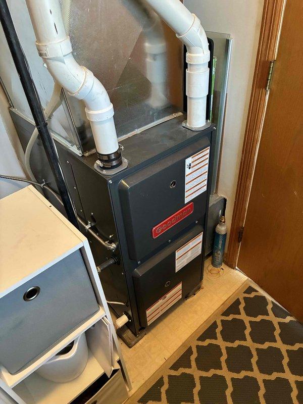 Performed a prepaid maintenance visit on an upright Goodman gas furnace, including cleaning the unit and completing a full operational check of the system. Inspected the PVC vent and condensate piping, access panels, and surrounding utility closet area, and found no frost, rust, or visible damage. Furnace was left clean and operating properly.