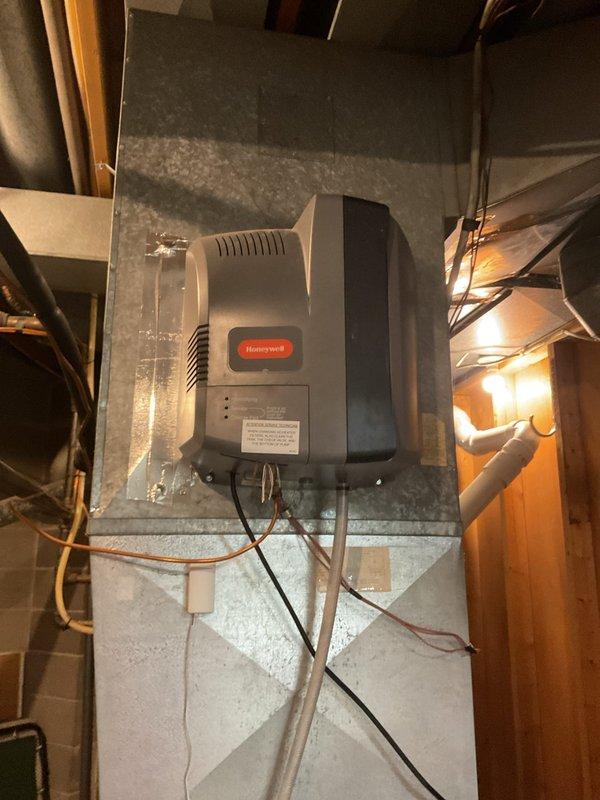 Performed scheduled furnace cleaning and safety inspection as part of a prepaid maintenance visit, cleaning the unit and verifying proper operation. Inspected the Honeywell whole-home humidifier mounted on the supply plenum along with its associated wiring, tubing, and sensor, and checked the condensate pump and drain line for secure connections and proper routing, with no leaks, corrosion, or visible damage observed.