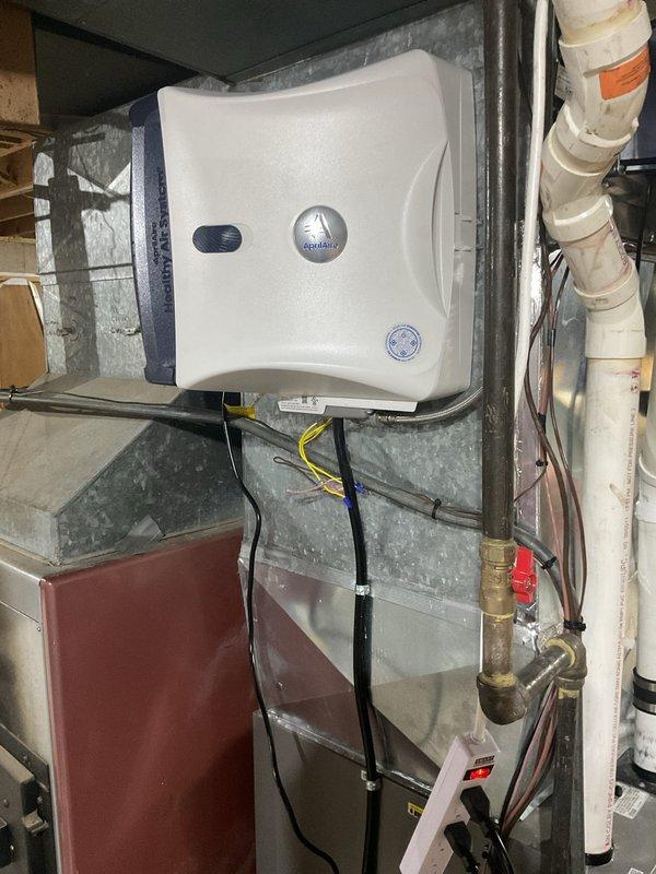 Performed a scheduled furnace cleaning and safety inspection on a 2011 Lennox gas furnace, checking the cabinet interior, wiring connections, condensate drain, and ductwork penetrations for proper sealing and condition. Activated and verified operation of the Aprilaire whole-house humidifier system, confirming proper control wiring and water supply connections. Equipment was found intact and operating normally, with no leaks, damage, or corrosion observed.