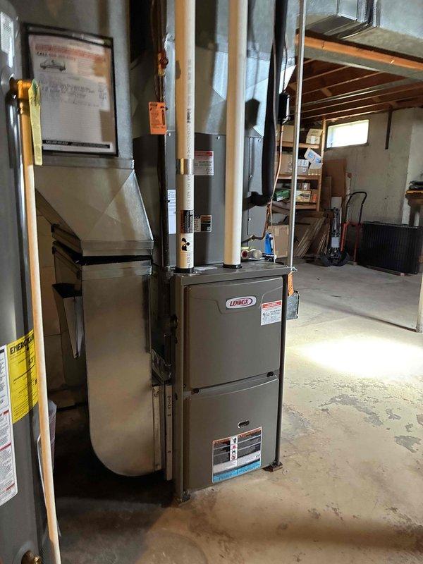 Performed annual preventive maintenance on a Lennox gas furnace, including cleaning the unit and inspecting the control board and low-voltage terminal connections, with all components found in good condition and no signs of rust, frost, or damage. The furnace was verified to be operating properly and the system was left in service.