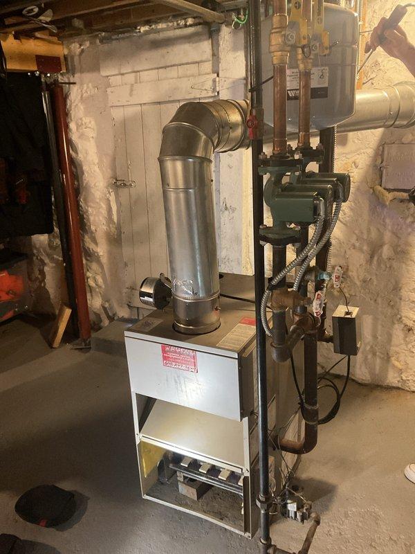 Performed a clean and check on the gas-fired boiler, including inspection of the burner assembly and combustion compartment, flue piping, and barometric damper. Checked the circulator pumps, associated piping and electrical connections, and verified the temperature and pressure gauge operation. Noted surface corrosion on the piping fittings at the boiler's outlet for future monitoring.