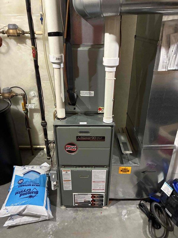 Performed prepaid cooling and heating system maintenance, including a complete clean and check of the A/C and the Ruud Achiever 90 Plus gas furnace. Combustion safety was verified by sampling flue exhaust at the PVC vent termination with a UEi CO95 carbon monoxide analyzer. Found a dirty air filter and replaced it with a customer-supplied filter; no visible frost, rust, or damage observed on the equipment.