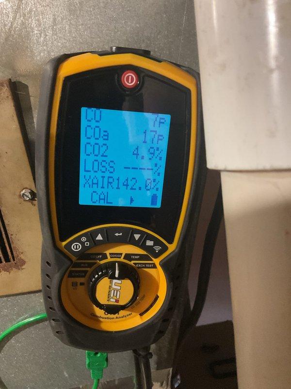 Performed a furnace tune-up on a 2003 Lennox gas furnace, including cleaning and inspection of the unit, and a camera scope of the heat exchanger. Combustion analysis was performed with a UEi analyzer, with readings of 7 ppm CO and 4.9% CO2 at the time of testing. Noted wet and stained concrete around the base of the furnace and a corroded vent register, both of which should be monitored for moisture or condensate issues.