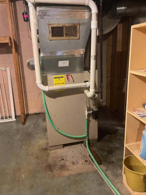 Performed a furnace tune-up on a 2003 Lennox gas furnace, including cleaning and inspection of the unit, and a camera scope of the heat exchanger. Combustion analysis was performed with a UEi analyzer, with readings of 7 ppm CO and 4.9% CO2 at the time of testing. Noted wet and stained concrete around the base of the furnace and a corroded vent register, both of which should be monitored for moisture or condensate issues.