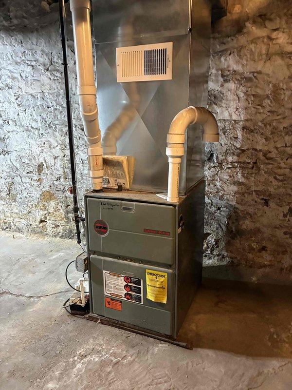 Performed a furnace tune-up on a Ruud gas furnace, including cleaning the unit and inspecting its overall condition. Removed the dirty air filter and replaced it with a customer-supplied filter to restore proper airflow. The unit was left clean and in good operating condition.