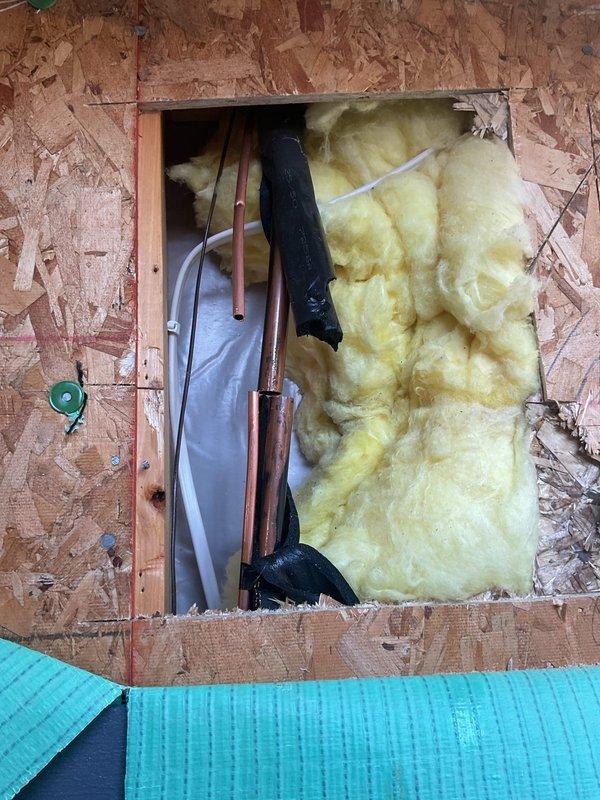 Located and repaired a refrigerant leak in the line set where a nail had punctured the copper tubing inside the exterior wall cavity, accessing the damaged section through an opening cut in the wall sheathing. Following the repair, pressure tested the system with nitrogen to verify leak-free integrity, then evacuated and recharged the A/C system with refrigerant to proper operating levels using a digital manifold gauge set.