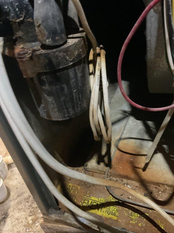Performed annual heating maintenance on a 15-year-old Ruud gas-fired furnace, including cleaning and a full operational inspection. Conducted a combustion analysis (O2 18.8%, CO 16 ppm, CO2 1.2%) to verify safe burner operation. Noted heavy rust and corrosion on nearby metal components and wiring in the cramped mechanical area, and found the unit in generally rough condition due to age.