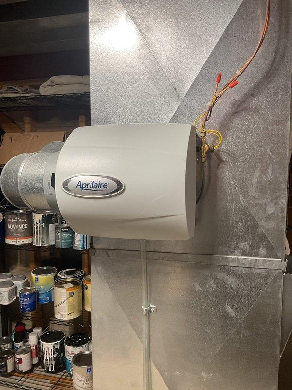 Performed a tune-up on a Carrier gas furnace with a coil cabinet and Aprilaire whole-home humidifier, including inspection of the furnace cabinet, condensate and PVC venting connections, refrigerant line, wiring, and filter slot. No frost, rust, or visible damage was found, and the humidifier installation on the supply plenum, with its bypass duct connection and wiring, was verified. The system was left in good operating condition.