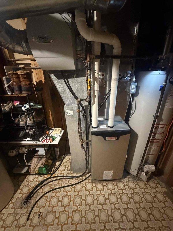 Performed a seasonal tune-up on a 9-year-old Lennox high-efficiency gas furnace, including cleaning and inspecting the unit and verifying proper operation. Installed a new filter in the Aprilaire whole-house humidifier/air cleaning system. Furnace and associated components were found in good working order with no additional issues noted.