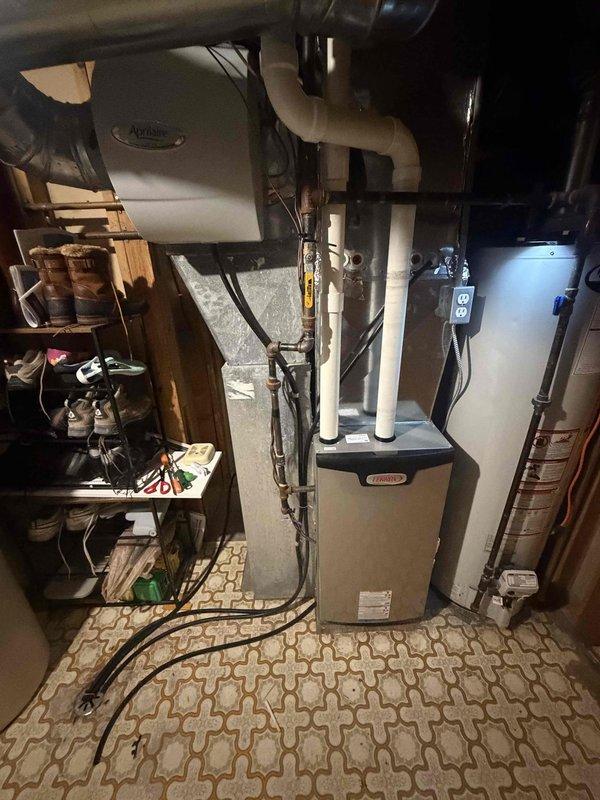 Performed a seasonal tune-up on a 9-year-old Lennox high-efficiency gas furnace, including cleaning and inspecting the unit and verifying proper operation. Installed a new filter in the Aprilaire whole-house humidifier/air cleaning system. Furnace and associated components were found in good working order with no additional issues noted.