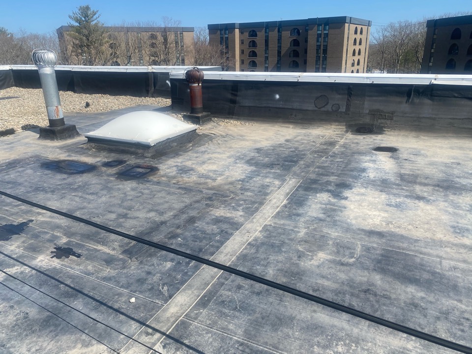 Weymouth, MA - Cleaned and patched multiple holes and delaminating patches in leak area on a EPDM ballast roofing system Weymouth, MA - Cleaned and patched multiple holes and delaminating patches in leak area on a EPDM ballast roofing system