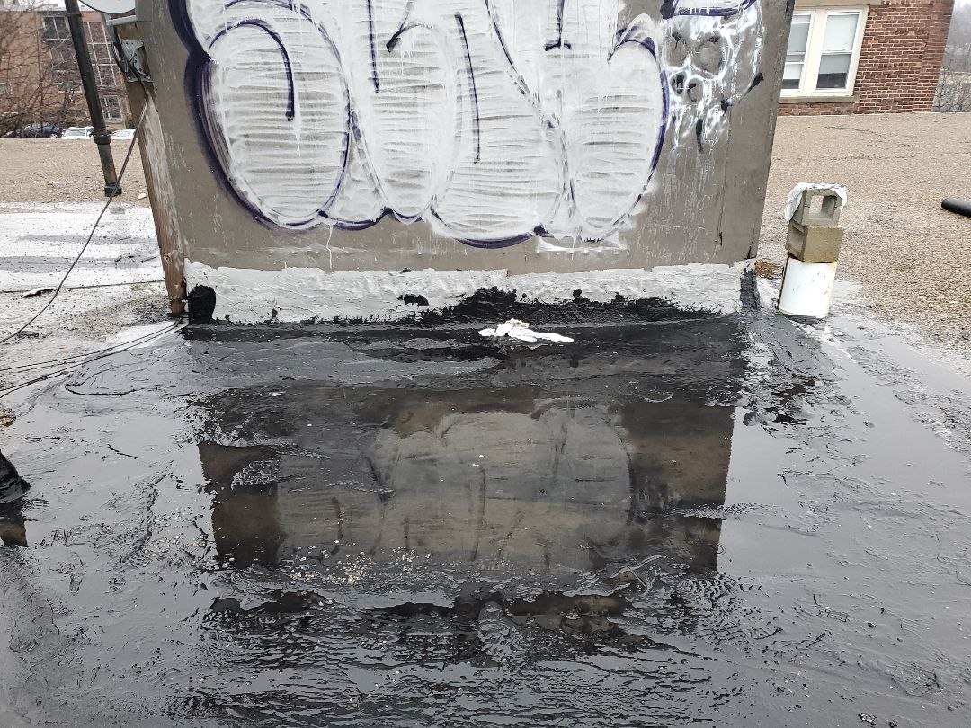 Boston, MA - Karnak patches in the rain on tar and gravel roof Boston, MA - Karnak patches in the rain on tar and gravel roof