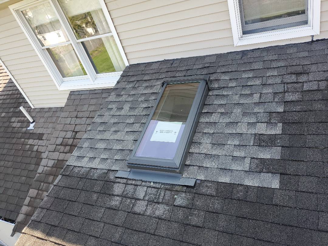 Peabody, MA - removed and replaced damaged architectural shingles from around skylight Peabody, MA - removed and replaced damaged architectural shingles from around skylight