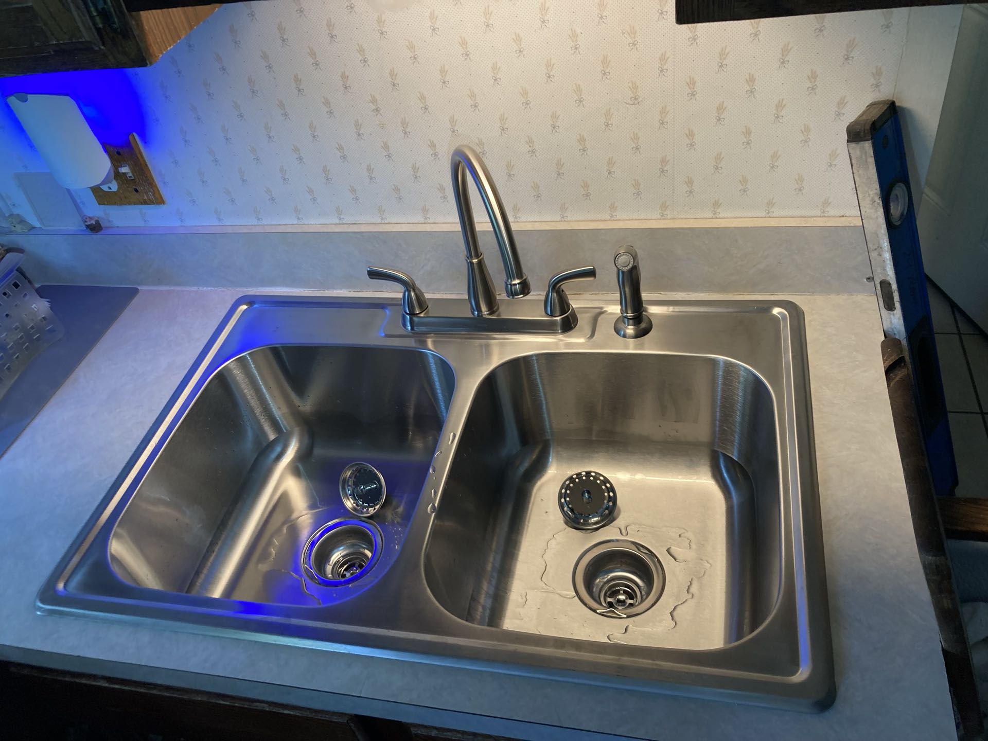 Install customer supplied kitchen sink and faucet.