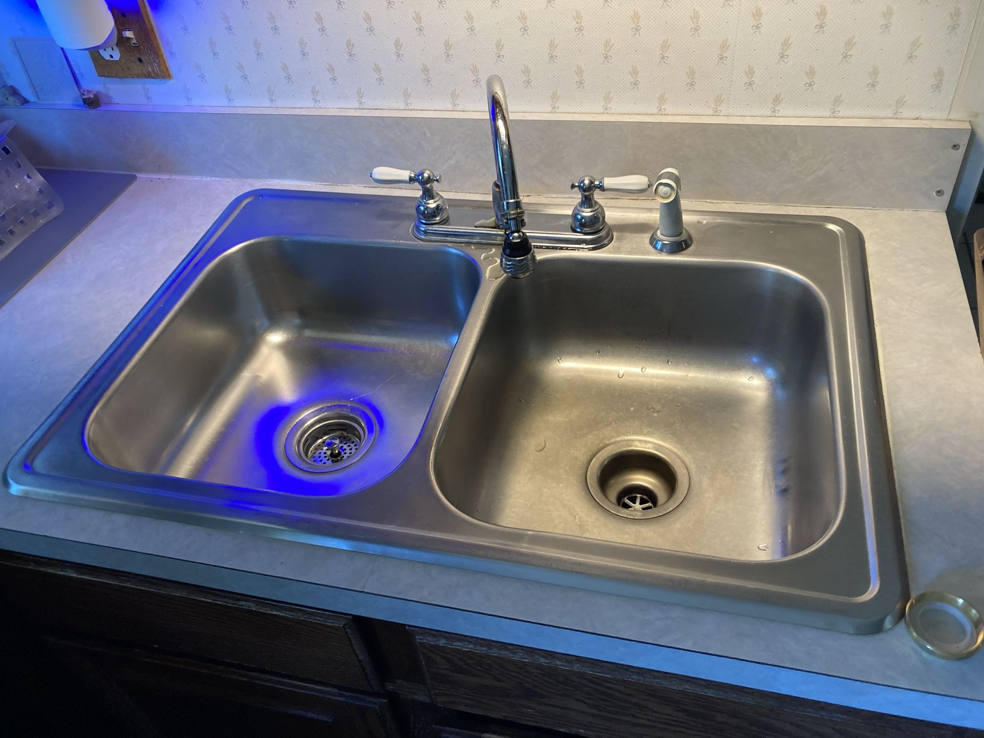 Install customer supplied kitchen sink and faucet.