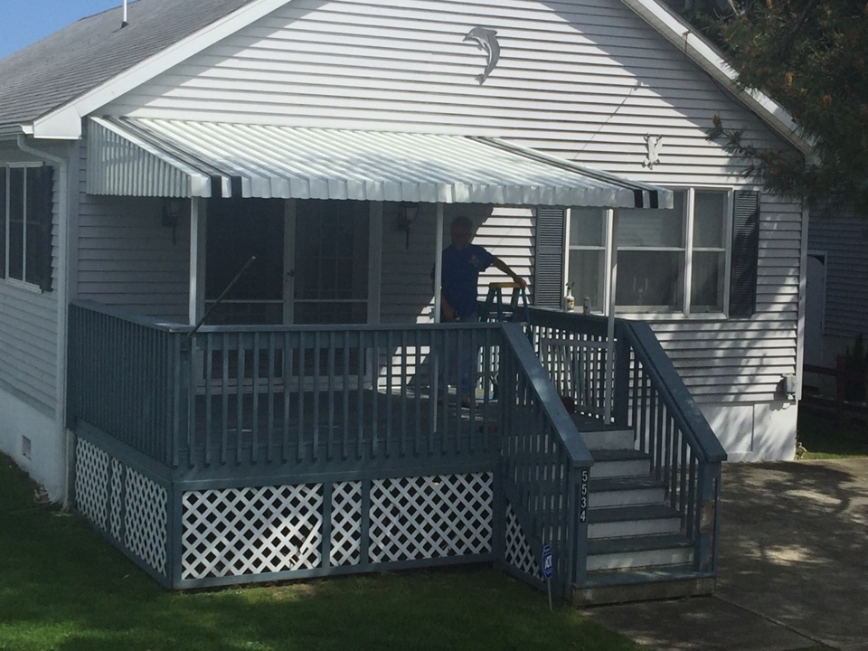 Ocean City, NJ - Installing a traditional aluminum awning on this Ocean City, NJ deck. This will allow the outdoor area to be used in the rain and will protect the owners from the hot summer sun. Aluminum awnings are just one of many shading solutions offers by Miami Somers. Call for your consultation today (609) 927-4133. Ocean City, NJ - Installing a traditional aluminum awning on this Ocean City, NJ deck. This will allow the outdoor area to be used in the rain and will protect the owners from the hot summer sun. Aluminum awnings are just one of many shading solutions offers by Miami Somers. Call for your consultation today (609) 927-4133.