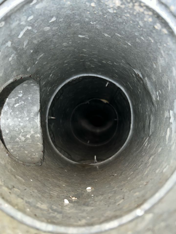Before and after pictures of cleaning metal air ducts to alleviate dust and dander improving air quality.