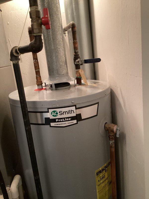 Responded to emergency call for water leakage from A.O. Smith ProLine commercial water heater. Inspection revealed corroded copper pipe fittings at top connection points causing water to spurt from tank. Shut off main water supply, replaced damaged fittings, and verified proper operation of all valves and connections. Tested system after repair with no further leaks observed.