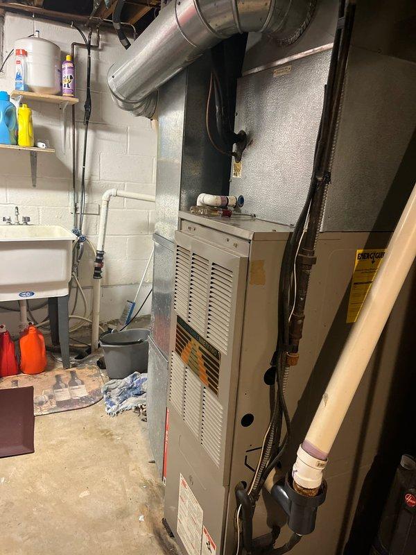 Conducted inspection of existing HVAC and water heating equipment in basement utility area. System evaluation included examination of furnace with connected ductwork, Bradford White water heater with Hydrojet technology, and associated PVC venting system. Photo documentation completed of all components and surrounding installation environment to support replacement estimate preparation.