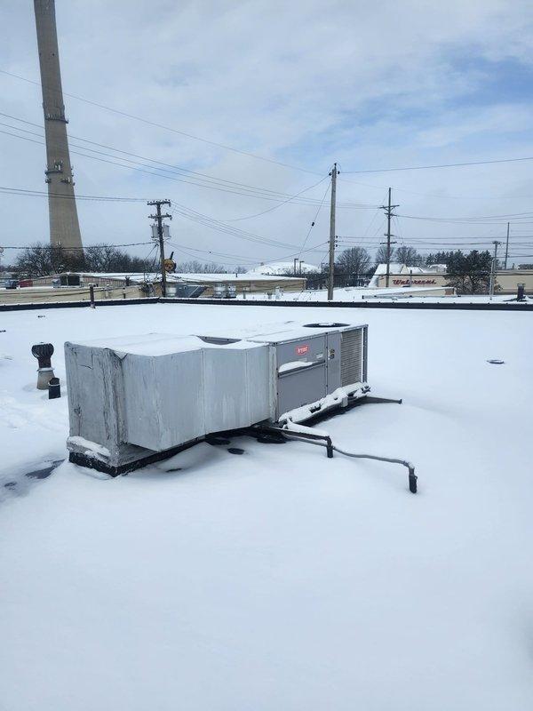 Responded to commercial no-heat call where thermostat was unable to exceed 64°F. Upon investigation of rooftop HVAC units, found significant snow accumulation on and around equipment which was restricting proper operation. Cleared snow from units and access panels to restore normal heating function.