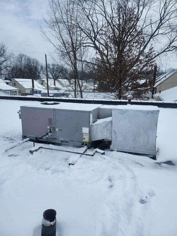 Responded to commercial no-heat call where thermostat was unable to exceed 64°F. Upon investigation of rooftop HVAC units, found significant snow accumulation on and around equipment which was restricting proper operation. Cleared snow from units and access panels to restore normal heating function.