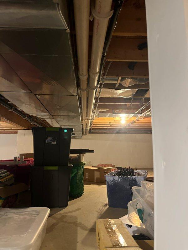 Conducted site assessment of unfinished basement area for HVAC replacement. Evaluated existing ductwork configuration and PVC ventilation system. Documented current mechanical system layout, noting exposed ceiling infrastructure and basement conditions for proper equipment sizing and installation planning.
