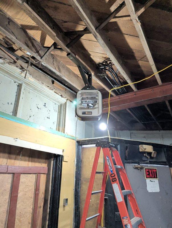 Installed two Markel electric heaters in commercial space - one mounted on brick wall in basement area and another on upper level wall. Units were properly secured to structural elements with appropriate electrical connections made to existing wiring. Work completed in accordance with commercial building specifications in an area under construction/renovation.