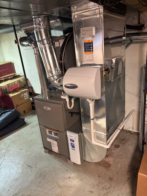 Completed full HVAC system installation including a Lennox furnace with connected ductwork and Aprilaire humidifier in the utility area, along with proper drainage and ventilation components. Installed matching Lennox outdoor AC unit on concrete pad with appropriate electrical connections, ensuring complete climate control system functionality for the residence.