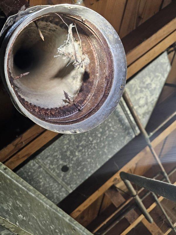 Completed flue pipe repair by addressing significant interior corrosion and rust buildup. Installed new metal ductwork connections to ensure proper ventilation from furnace system to exterior, eliminating potential safety hazards and restoring proper exhaust function.