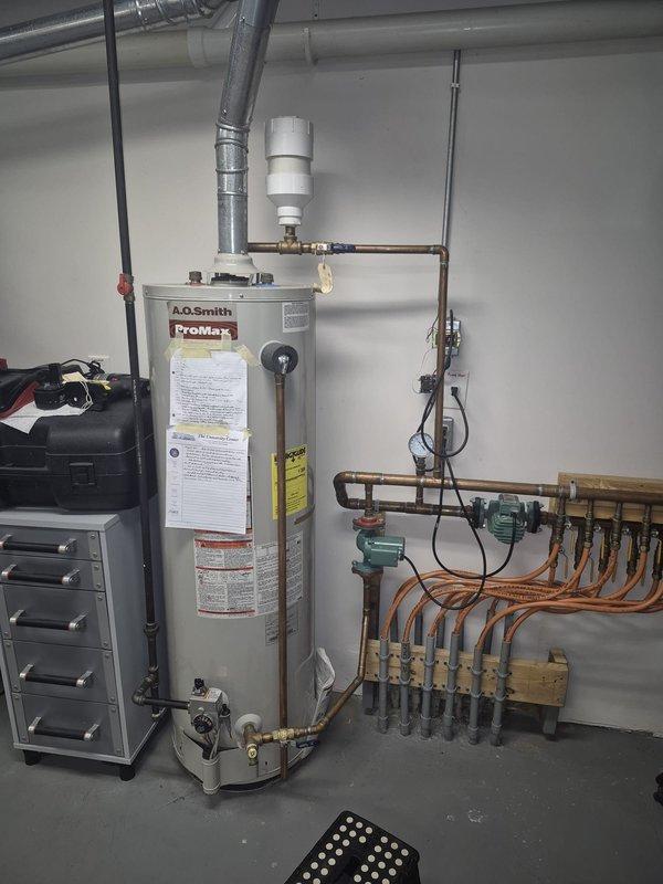 Responded to service call for non-functioning radiant floor heating system in basement. Inspected A.O. Smith Premier water heater and associated hydronic distribution system. Identified circulation pump issue at the manifold assembly where multiple PEX tubing lines connect. Serviced pump, verified proper operation of pressure gauge readings, and confirmed restored functionality of the radiant floor heating system.