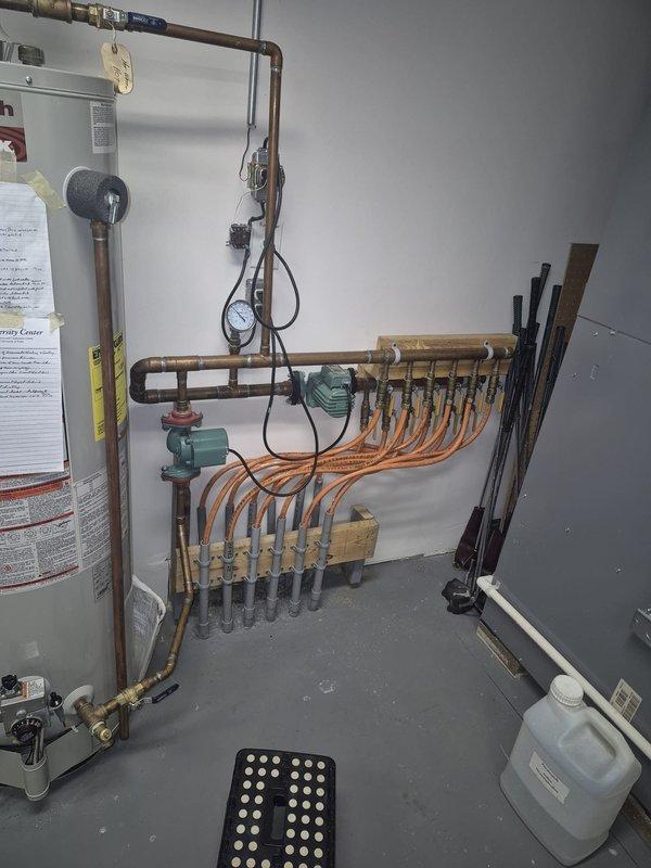 Responded to service call for non-functioning radiant floor heating system in basement. Inspected A.O. Smith Premier water heater and associated hydronic distribution system. Identified circulation pump issue at the manifold assembly where multiple PEX tubing lines connect. Serviced pump, verified proper operation of pressure gauge readings, and confirmed restored functionality of the radiant floor heating system.