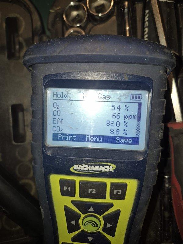 Responded to no-heat emergency call for boiler failure during extreme cold conditions. Upon inspection, identified combustion efficiency issues with the system operating at only 82.0% efficiency and elevated CO levels at 66 ppm. Performed combustion analysis using Bacharach analyzer, adjusted air-fuel mixture, and serviced control board to restore proper heating function and improve safety parameters.