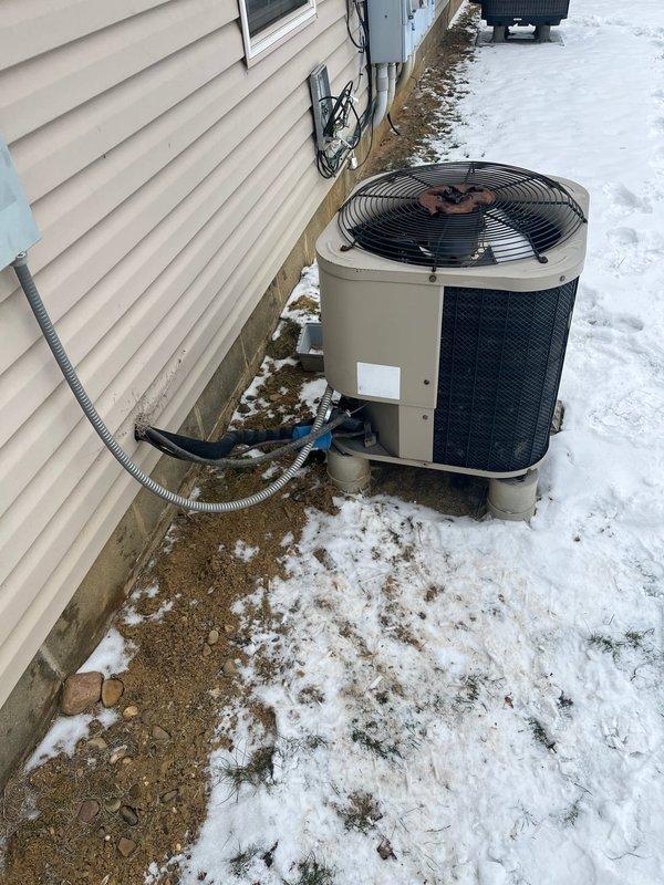Conducted comprehensive heat pump replacement assessment for customer (referral through Rich's connection). Documented existing outdoor unit showing age and winter wear, and examined attic access to evaluate ductwork configuration. Customer is comparing multiple quotes; recommended aggressive pricing strategy for competitive proposal.