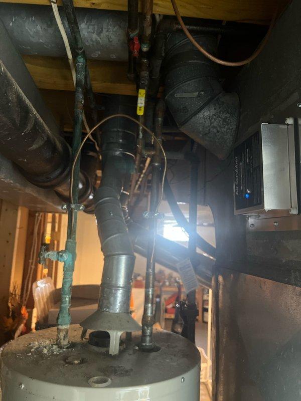 Conducted furnace and AC retrofit project in basement mechanical room. Existing Carrier WeatherMaker furnace was evaluated and documented along with current ductwork configuration. Comprehensive assessment of existing HVAC system completed to prepare for replacement with new equipment while maintaining proper integration with water heater and existing duct system.