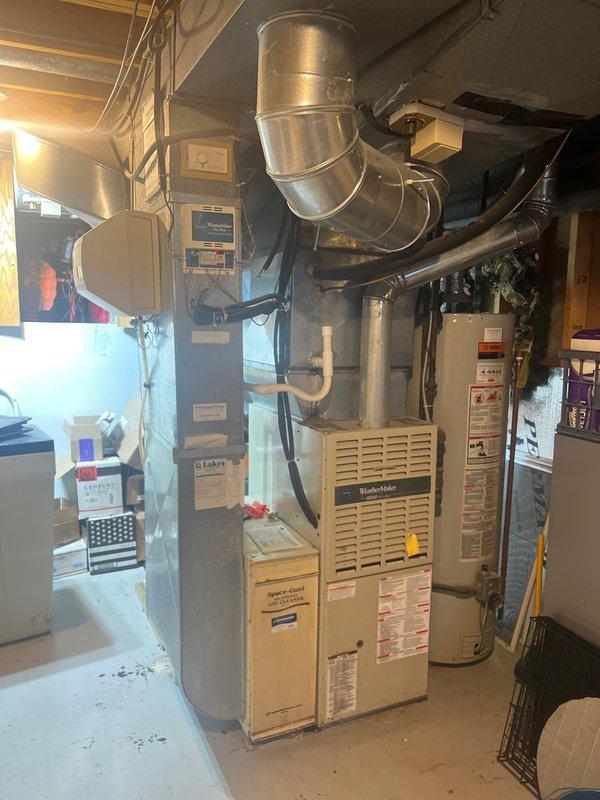 Conducted furnace and AC retrofit project in basement mechanical room. Existing Carrier WeatherMaker furnace was evaluated and documented along with current ductwork configuration. Comprehensive assessment of existing HVAC system completed to prepare for replacement with new equipment while maintaining proper integration with water heater and existing duct system.