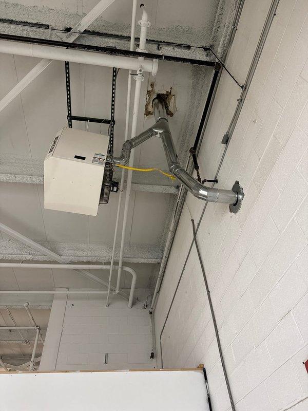 Successfully installed customer-supplied Reznor unit in commercial ceiling space, properly securing it with metal mounting brackets. Connected the unit to existing ductwork system and verified proper operation of the circular fan component.