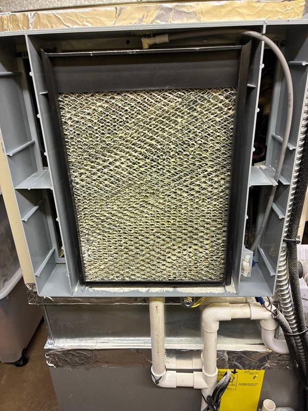 Responded to service call for humidifier maintenance. Accessed HVAC system and inspected humidifier components. Replaced water panel in evaporative humidifier unit as per manufacturer's recommendation to ensure proper humidity control and system efficiency.