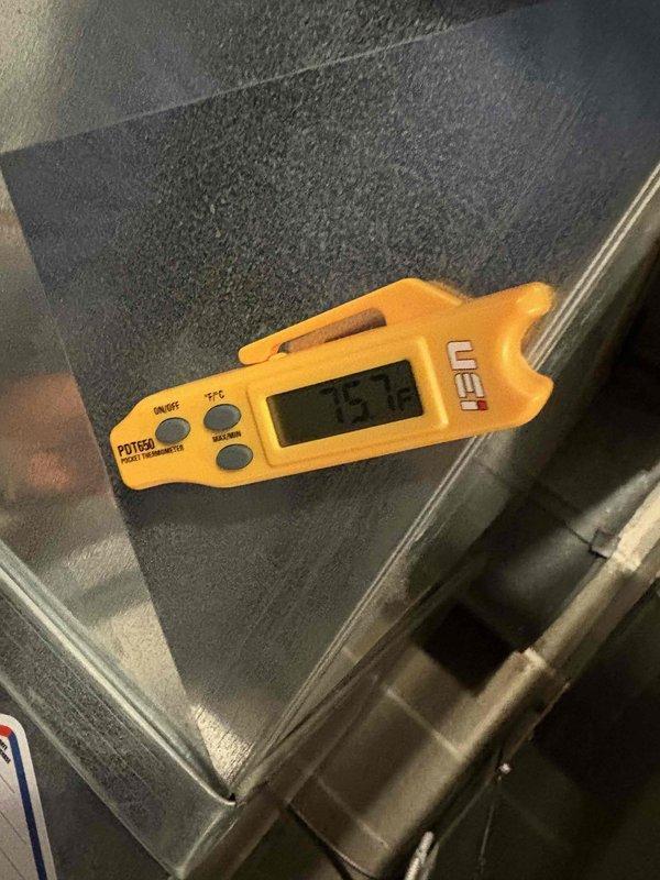 Performed fall maintenance on commercial HVAC system. Conducted temperature measurements using UEi PDT52A digital thermometer, recorded reading of 75.7°F. Inspected electrical connections and wiring, focusing on the red, yellow, and black wire bundles and associated copper components.