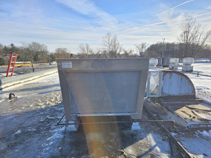 Successfully completed replacement of game room RTU with new Luxaire commercial rooftop unit. Installed unit on existing concrete pad, connected to existing ductwork, and verified proper system operation. Equipment installation was performed under winter conditions with all connections properly sealed and secured.